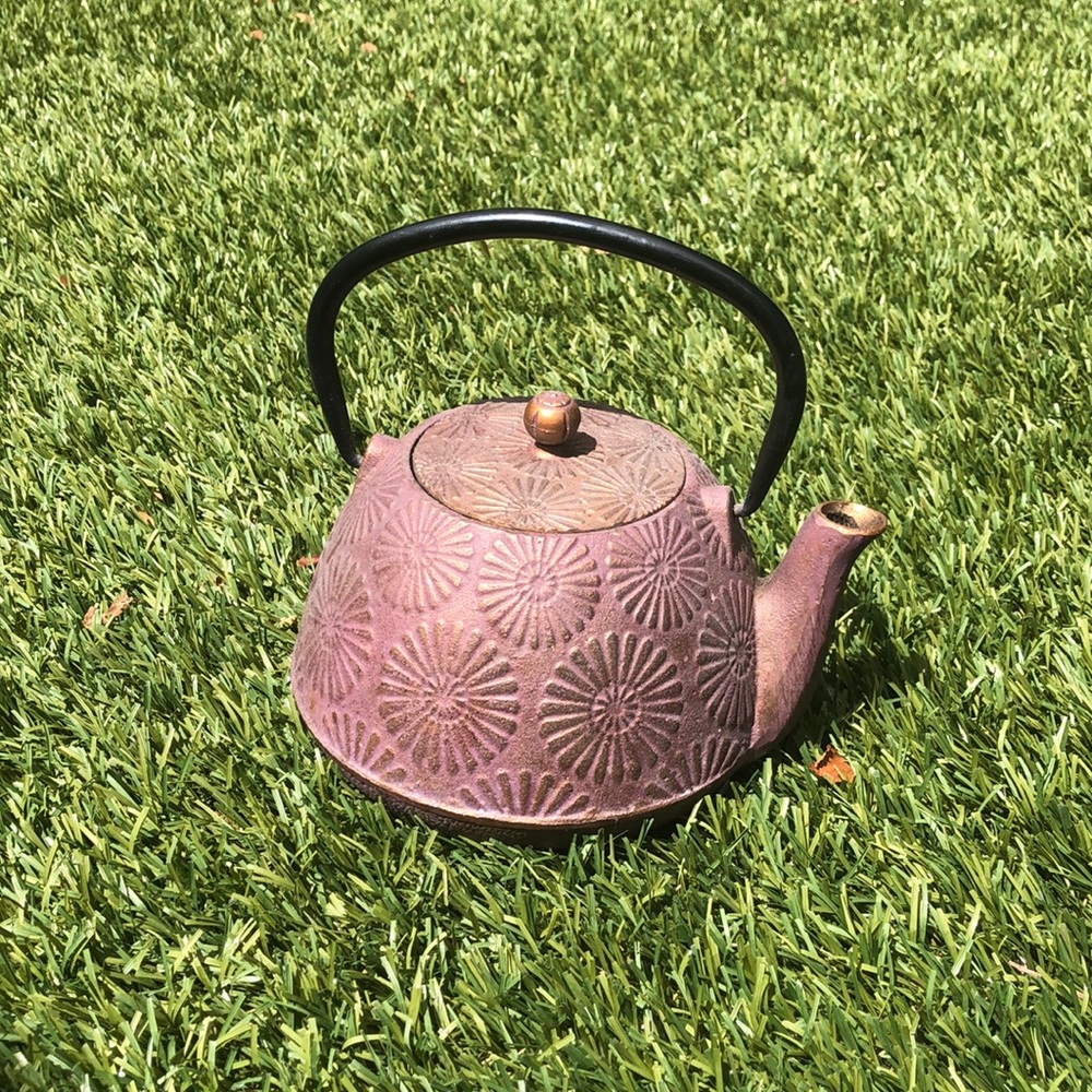 Cast iron tea pot with sunburst design